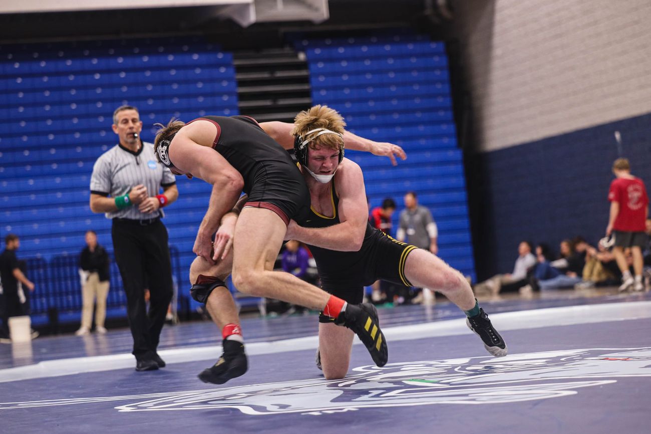 Two wrestlers in a scramble beside the referee at Regionals